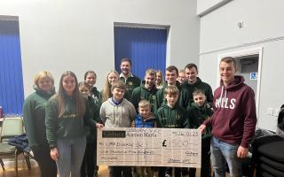 Members of Gisburn Young Farmers handing over the cheque