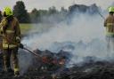 Firefighters attend a blaze after a stack of hay bales were set alight.