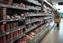A shopper in the fresh meat aisle in a supermarket, as the surging cost of carbon dioxide could add £1.7bn to the cost of British groceries, according to new analysis