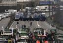 Tractors face military vehicles on a blocked highway, Wednesday, Jan. 31, 2024 in Chilly-Mazarin, south of Paris. Farmers have captured France's attention by showering government offices with manure and besieging Paris