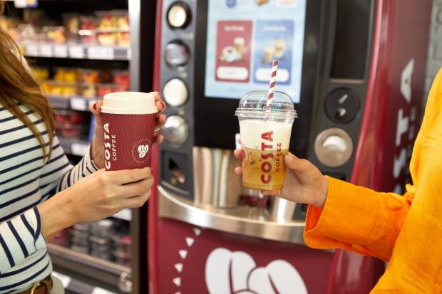 The Northern Farmer: One person holding a hot drink (left) and another person holding a cold drink (right) in front of a new Costa Express machine (Costa Coffee)