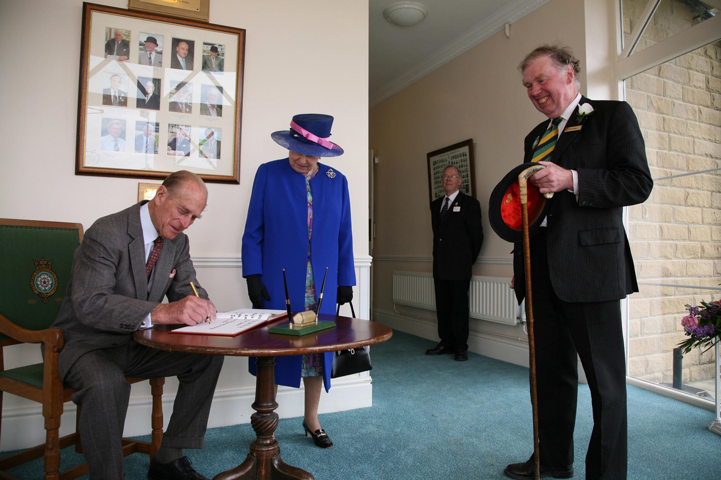 At the 150th Great Yorkshire Show in Harrogate, in 2008, the Duke of Edinburgh signs the visitors book after the Queen watched by Bill Cowling, Honorary Show Director