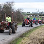 SINGLE FILE: A line of tractors old and new