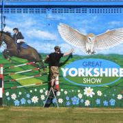 Artist Sam Porter at his new mural at the Great Yorkshire Showground Picture: GERARD BINKS