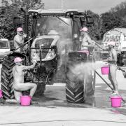 Farming friends bare all in tractor washing photo for charity